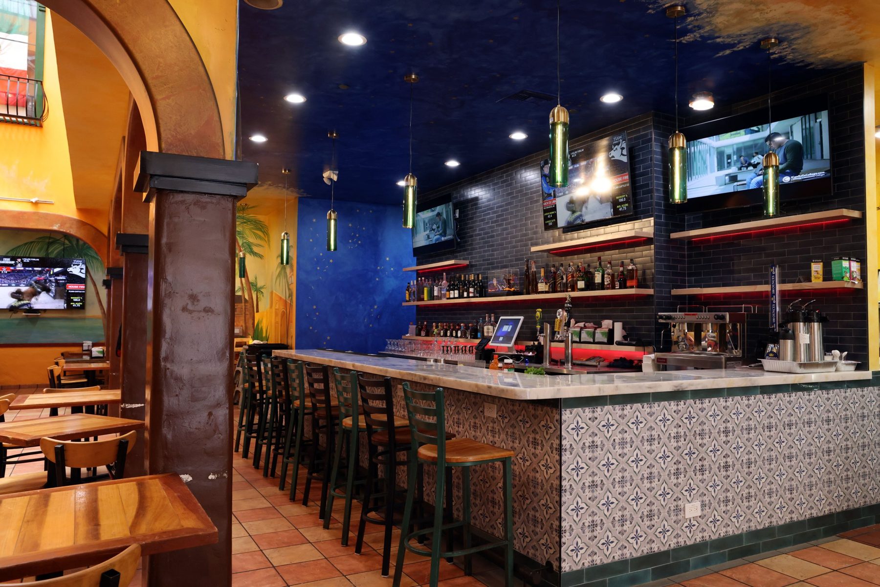 The finished bar under the painted ceiling, marble top and tiled front