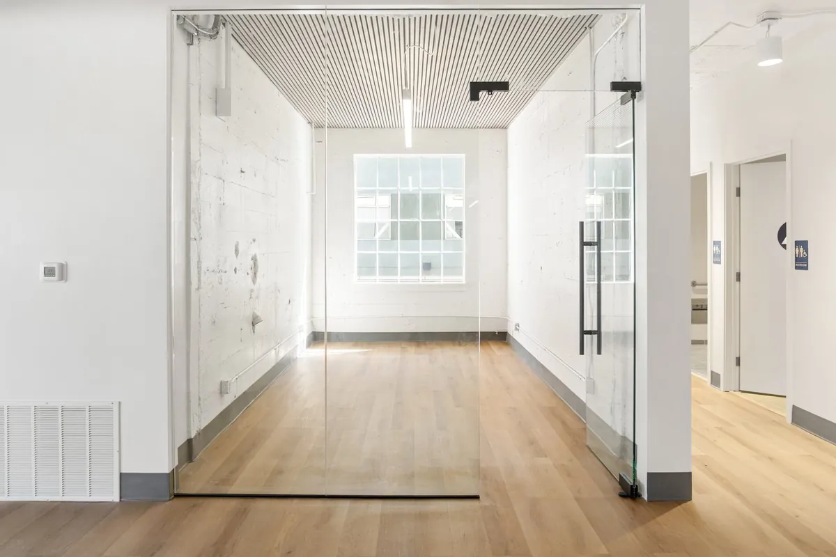 Glass-front conference room with full-height glass door