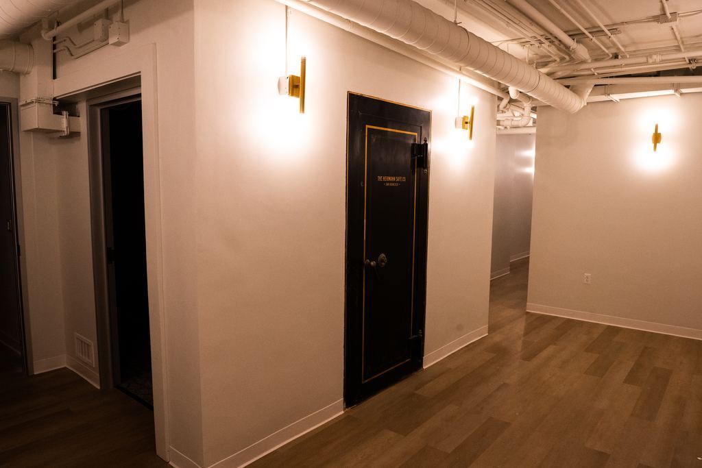The bank’s original vault door kept in place, with new brass sconces
