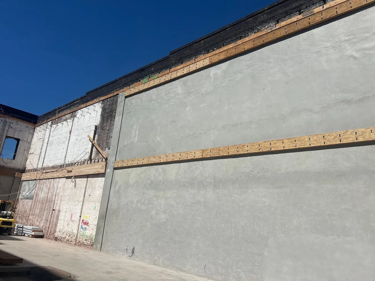 New shotcrete shear wall applied to the inside of the brick wall at Bluxome St